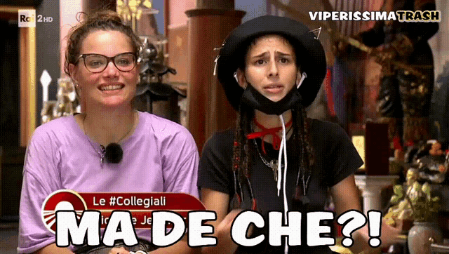 two women are sitting next to each other and one of them is wearing a hat that says " ma de che "