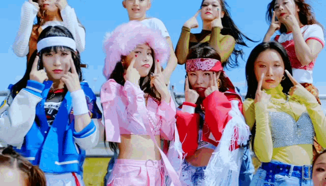 a group of girls are standing next to each other and making funny faces .