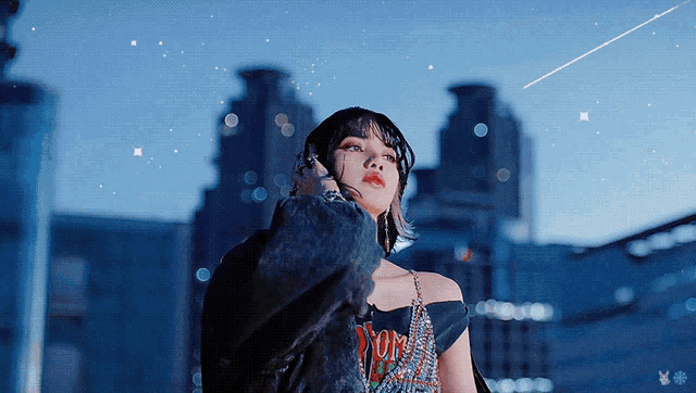 a woman stands in front of a city skyline and a shooting star