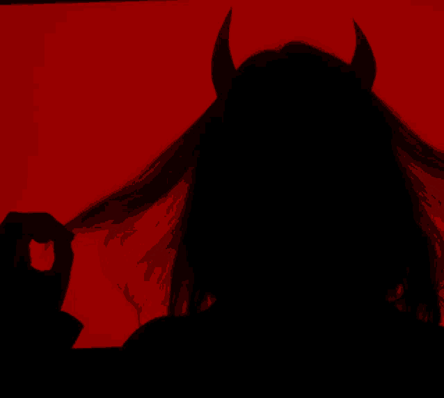 a silhouette of a devil with horns on a red background