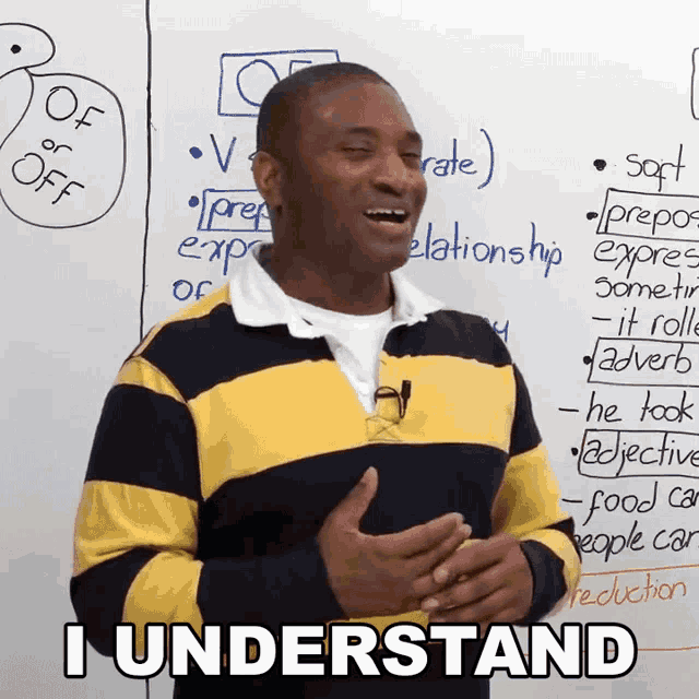 a man in a yellow and black striped shirt says i understand in front of a white board