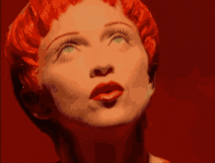 a woman with red hair and a white dress is dancing