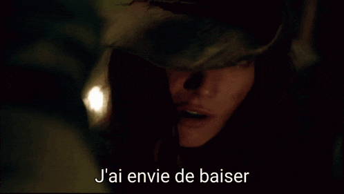 a close up of a woman 's face with the words " t'aime pas ca baiser " below her