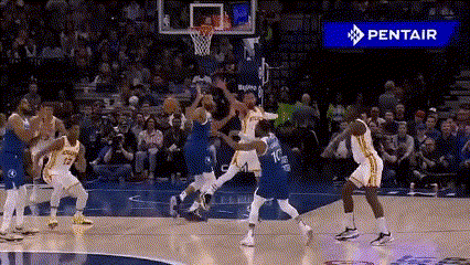 a group of basketball players are playing a game of basketball on a court .