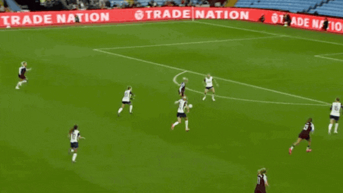 a soccer game is being played in front of a power up your trading banner