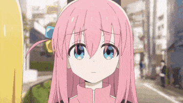 a pink haired anime girl with blue eyes is standing on a street .