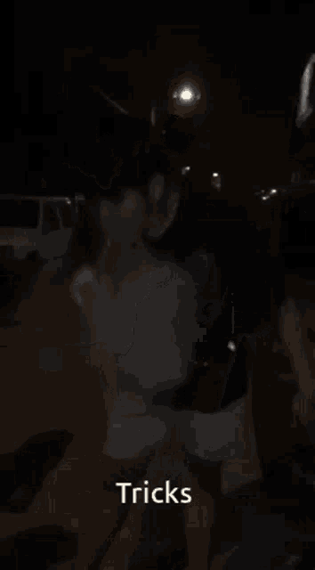 a man smoking a cigarette with the words tricks on the bottom right
