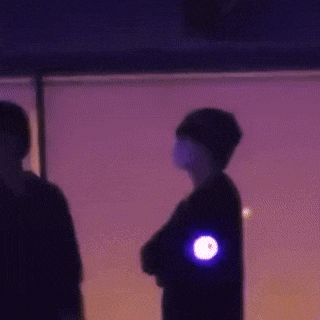 a person with a purple light on their arm