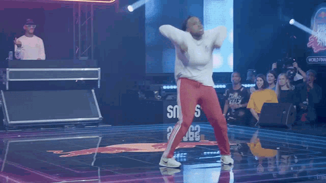 a man is dancing on a stage in front of a sign that says world finals