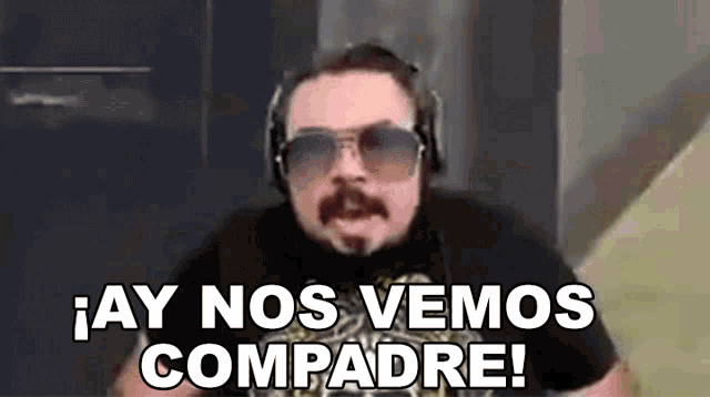 a man wearing headphones and sunglasses is making a funny face and saying `` ay nos vemos compadre ! ''