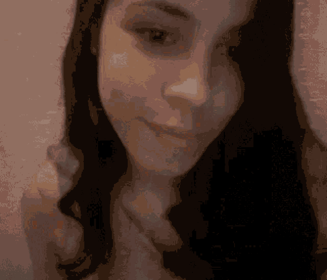 a close up of a woman 's face with long hair