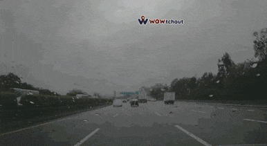a car is driving down a highway with the words wow without on the bottom right