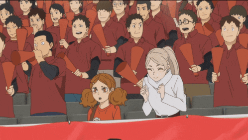 a crowd of people wearing red shirts are holding megaphones