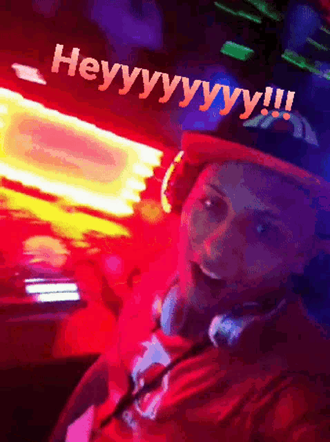 a man wearing headphones and a hat that says heyy