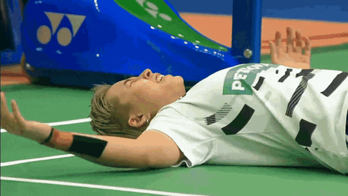 a person laying on the floor with a shirt that says petra