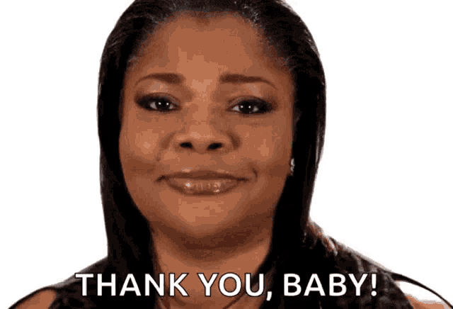 a woman is smiling and saying thank you baby