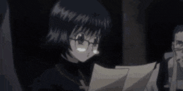 a girl wearing glasses is holding a piece of paper .