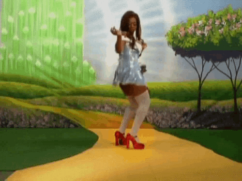 a woman in a blue dress is dancing on a yellow path