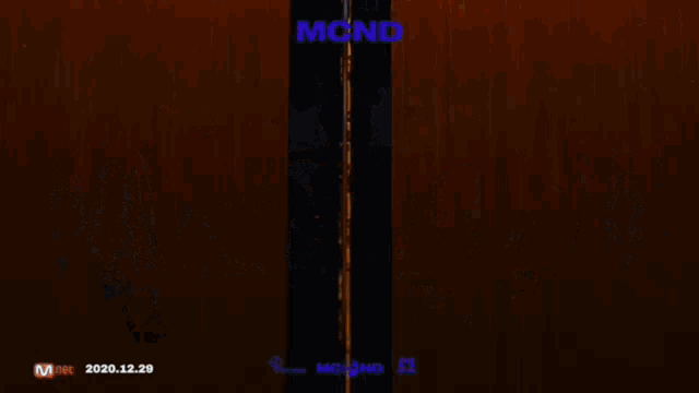a blurry picture of a group of young men with the word mcnd on the top