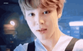 a close up of a person 's face with a blurred background .