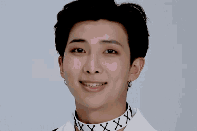 a close up of a person 's face with a heart drawn on the wall behind them