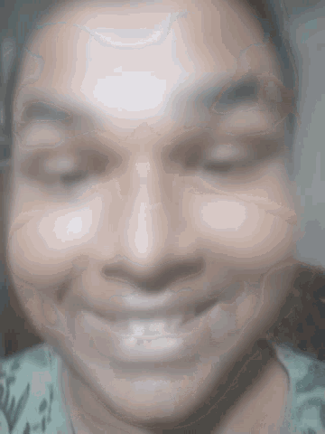 a blurry picture of a person 's face with a smile on it