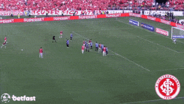 a group of people are laughing in a stadium with a betfast logo in the corner
