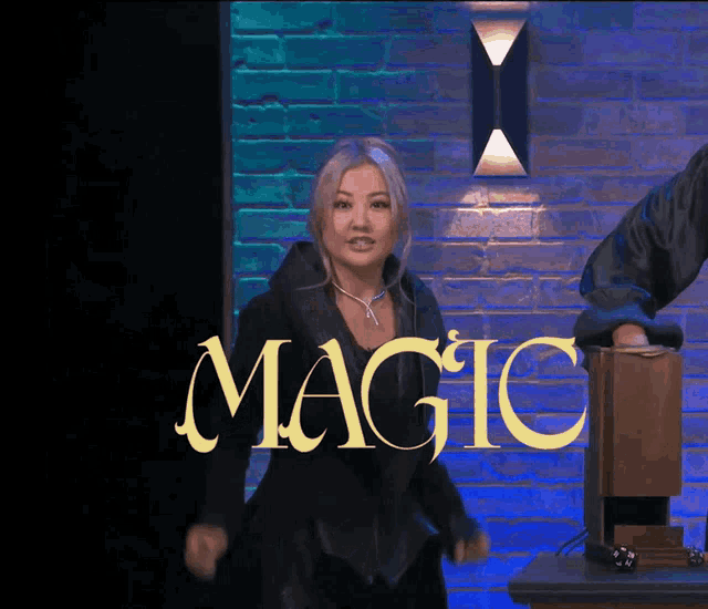 a woman stands in front of a sign that says " magic "