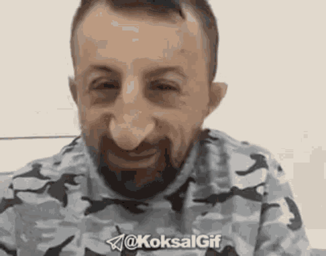 a man with a beard and big nose is smiling .