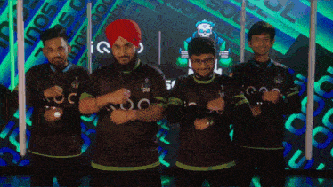 a group of men are posing for a picture and one of them has a turban
