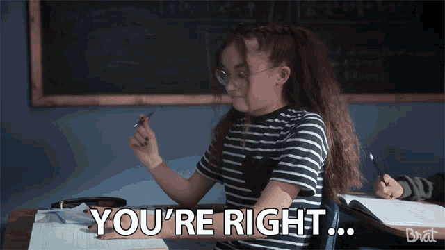 a girl sitting at a desk with the words you 're right below her