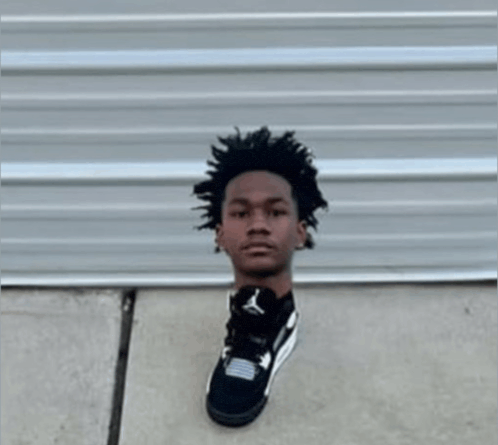 a man 's head is cut out of a black shoe