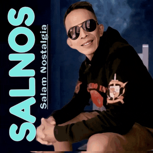 a man wearing sunglasses sits in front of a sign that says salam nostalgia