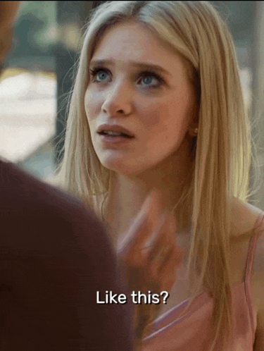 a woman in a pink dress is talking to a man and says like this
