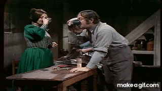 a man is kissing a woman on the cheek in a scene from a movie