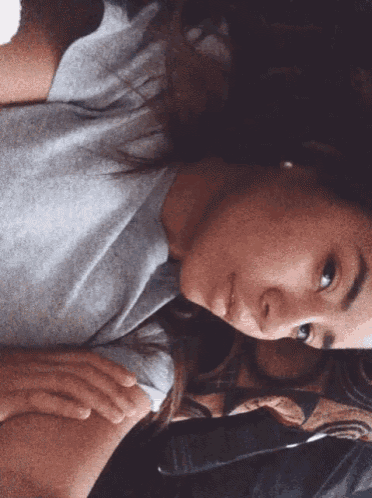 a woman is laying down with her eyes closed and her hands on her chest
