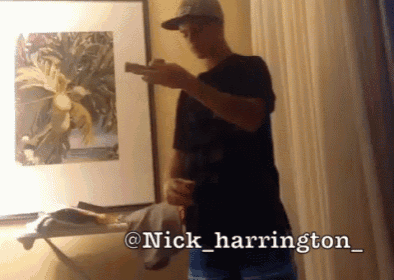 a man standing in front of a picture with the name nick harrington on the bottom right