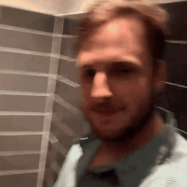 a blurry picture of a man with a beard standing in a bathroom