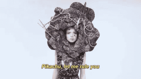 a woman is wearing a large flower shaped hat and says pikachu let me rule you