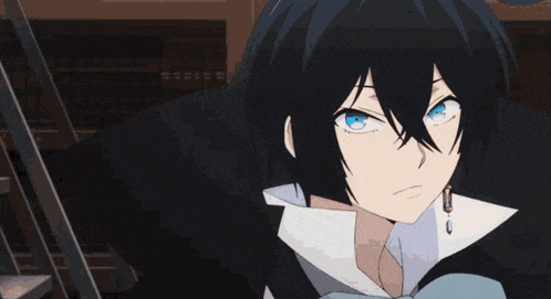 a close up of a person 's face with blue eyes and black hair