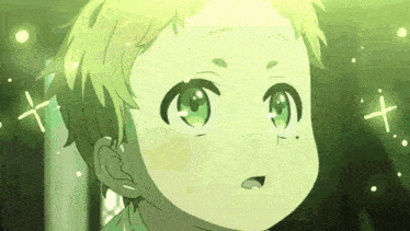 a close up of a child 's face with green eyes and a yellow background .
