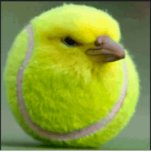 a tennis ball that looks like a bird with a red beak