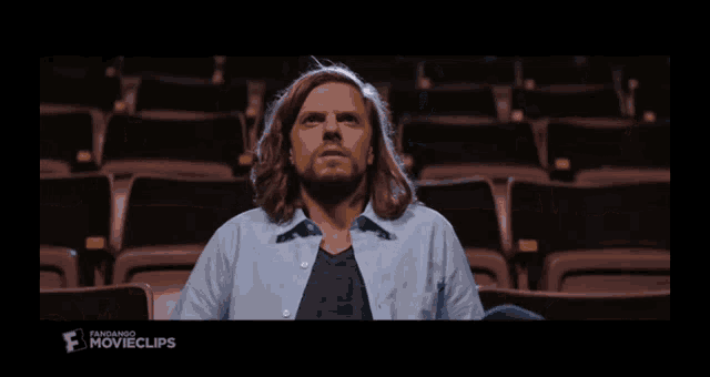 a man with long hair and a beard is in a movie clip