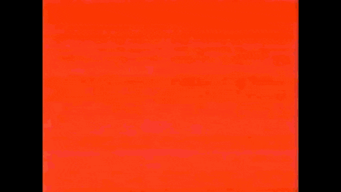 kirby is flying through the air with a red background and a lot of fire coming out of his mouth .