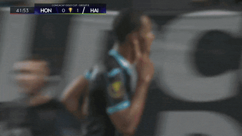 a soccer player in a black and blue jersey with the number 77 on it