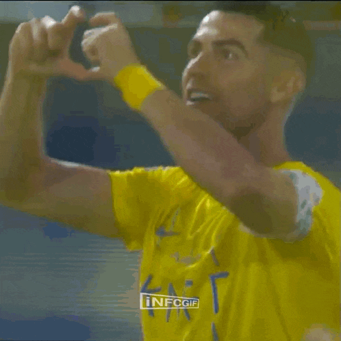 a man in a yellow nike shirt is giving a thumbs up