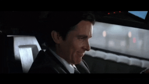 a man sitting in a car with the words does it come in audiobook above him