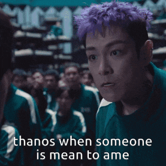 a man with purple hair has the words thanos when someone is mean to ame below him