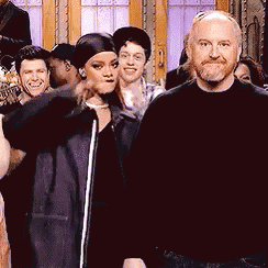 a group of people are posing for a picture including a man with a beard and a woman in a black dress
