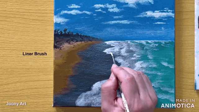 a person is using a liner brush on a painting of the ocean